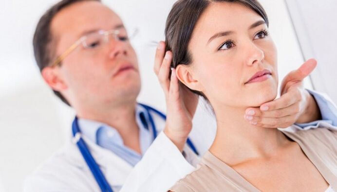 doctor examines a patient with neck pain